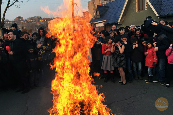Armenian people gathered around festive bonfire to celebrate the feast of Trndez